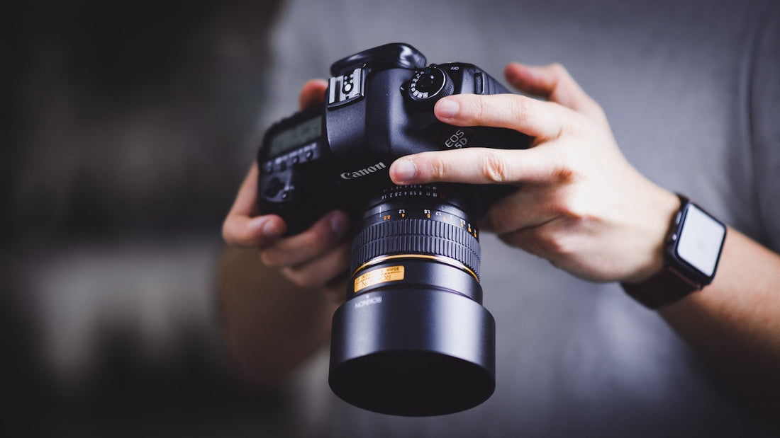 man holding DSLR camera