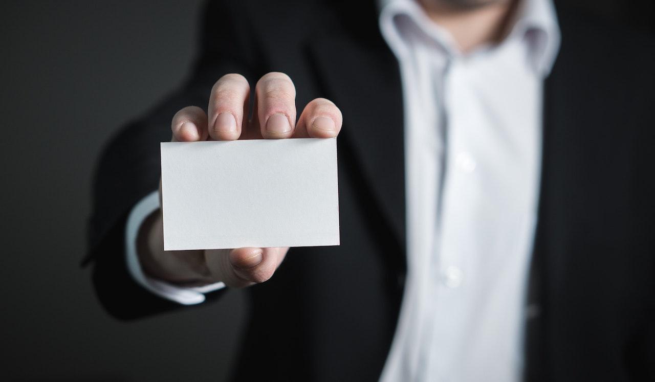 man holding blank business card
