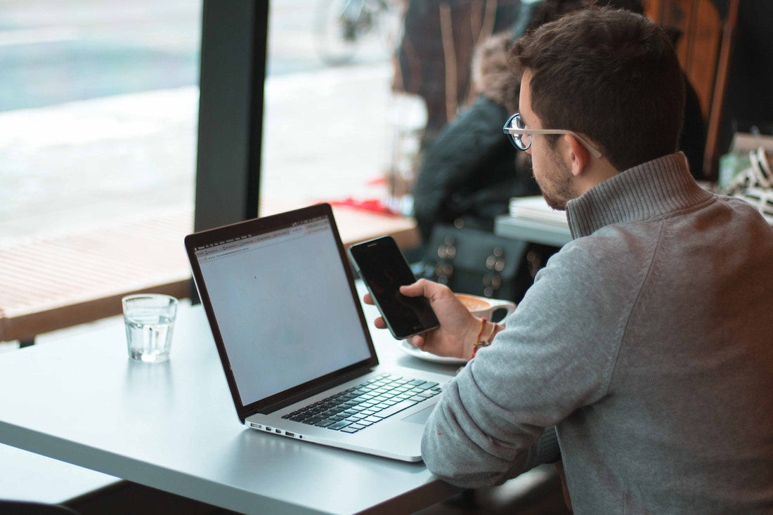 man on phone and computer