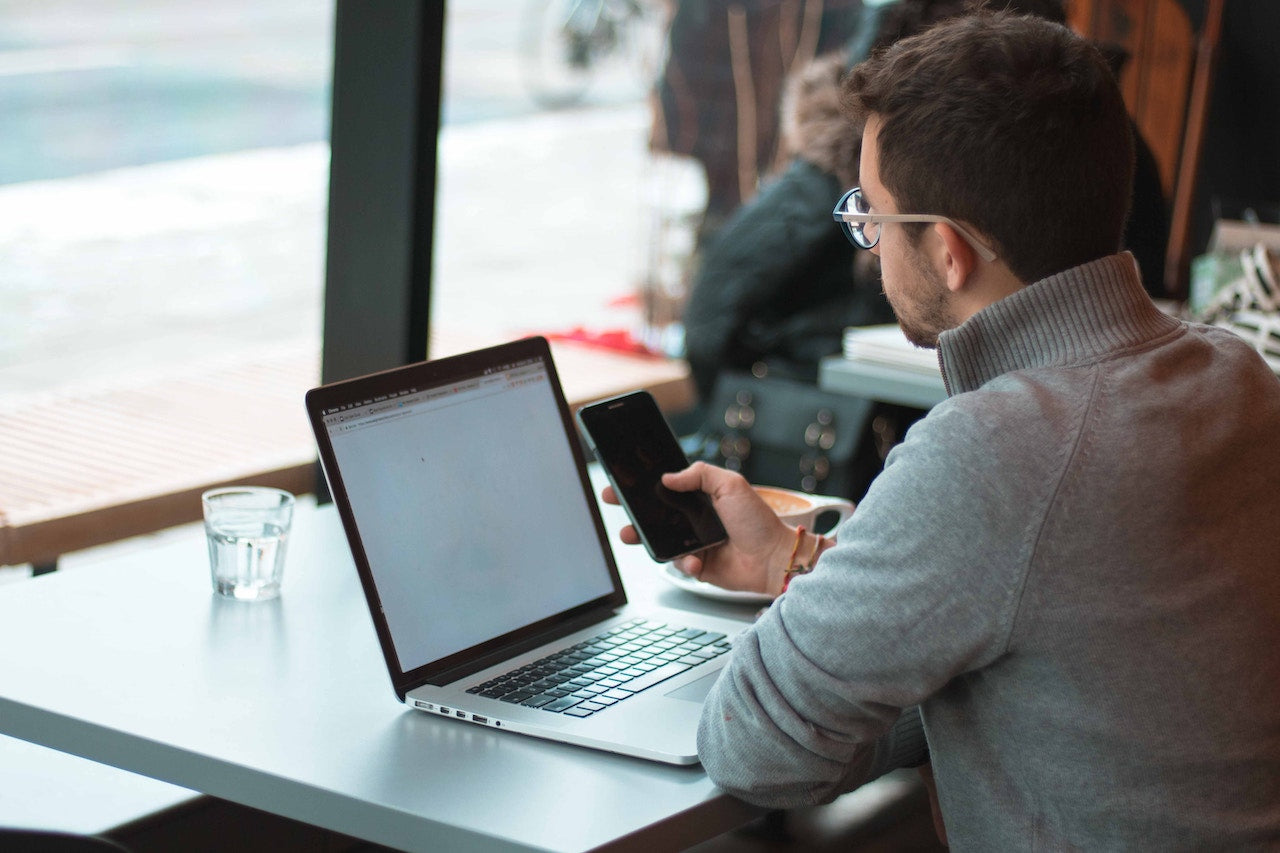 man on phone and computer