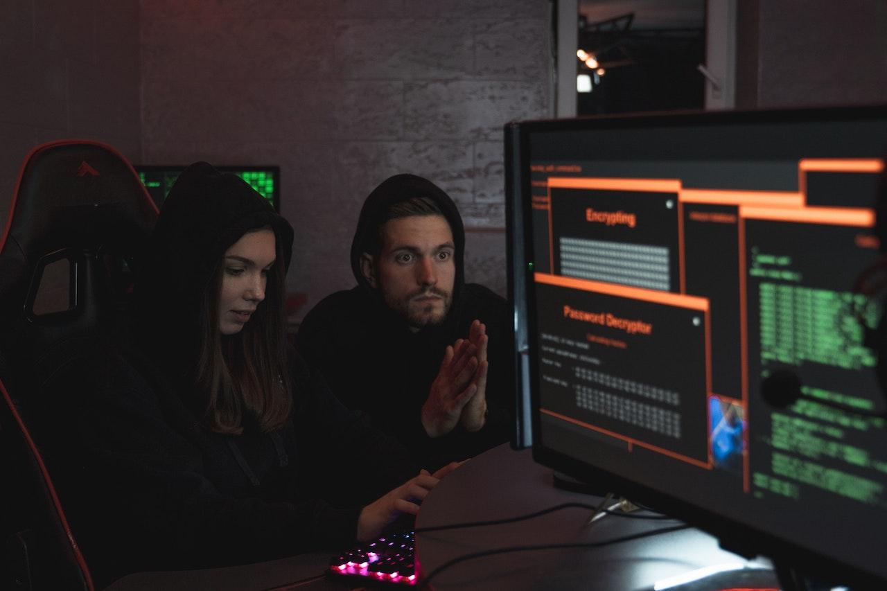 team of hackers committing crime on computer