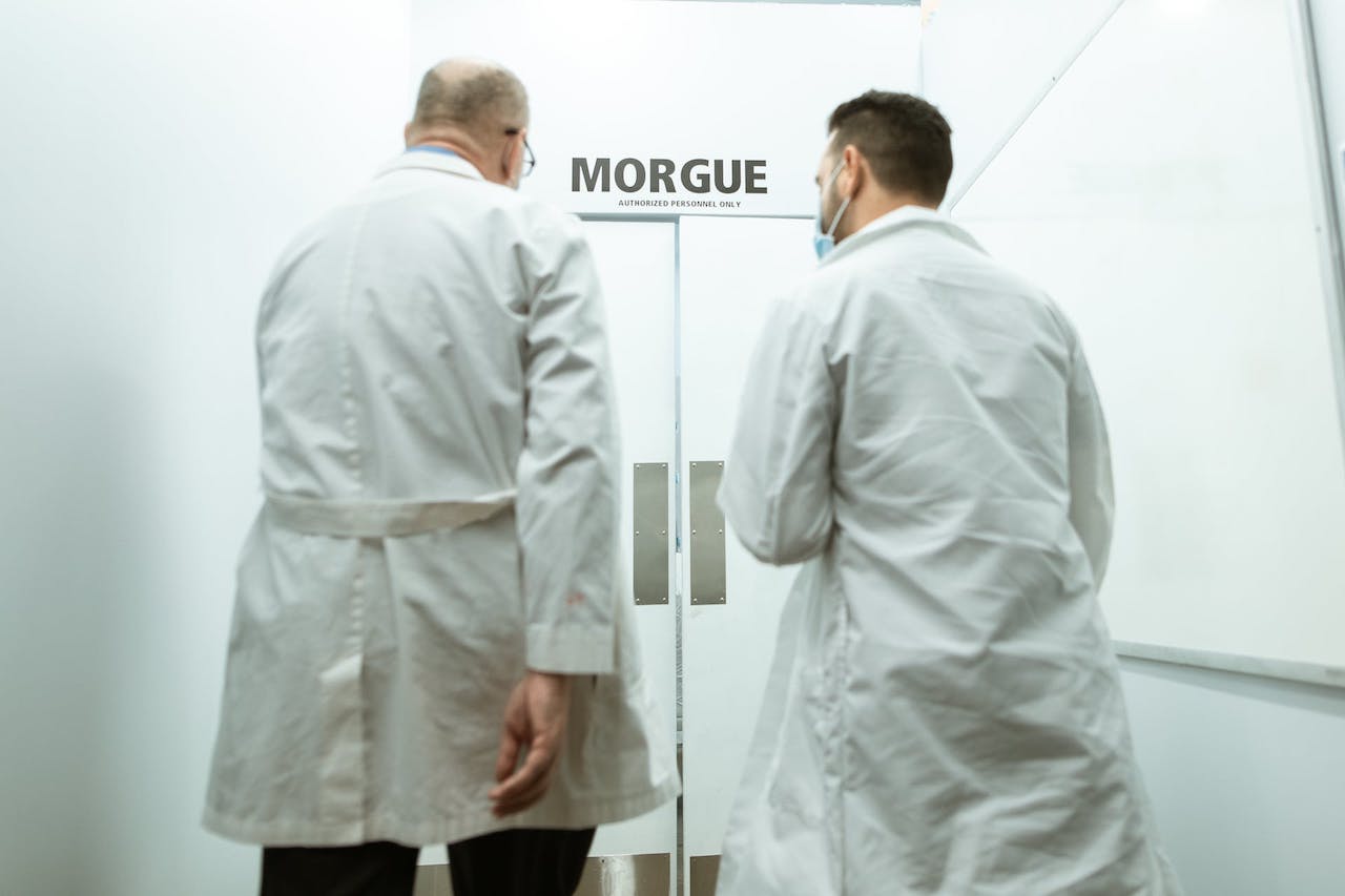 two doctors in white coats entering morgue